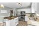 Bright kitchen equipped with stainless steel appliances, a functional island, and white cabinetry at 2700 Ross Rd, Durham, NC 27703