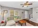 Bright living room with hardwood floors, a cozy sofa, and a ceiling fan for added comfort at 2700 Ross Rd, Durham, NC 27703