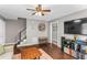 Spacious living room with hardwood floors, a comfortable sofa, and a staircase to the second floor at 2700 Ross Rd, Durham, NC 27703