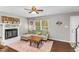 Inviting living room featuring hardwood floors, a fireplace, and a comfortable gray sofa at 2700 Ross Rd, Durham, NC 27703