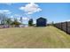 Large backyard with a fenced perimeter under a bright blue sky at 283 Raynor Rd, Spring Lake, NC 28390