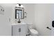 Well-lit half bathroom featuring modern fixtures, a vanity, and black and white tile flooring at 283 Raynor Rd, Spring Lake, NC 28390