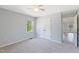 Cozy bedroom with neutral paint, carpeted floor, ceiling fan, and a window overlooking greenery at 283 Raynor Rd, Spring Lake, NC 28390