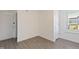 Minimalist bedroom featuring neutral walls, wood-look floors, and natural light from the window at 283 Raynor Rd, Spring Lake, NC 28390