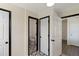 Hallway with stylish black and white tile flooring leading to adjoining rooms and a half bathroom at 283 Raynor Rd, Spring Lake, NC 28390