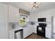 Well-appointed kitchen with white cabinets, stainless steel appliances, and a modern light fixture at 283 Raynor Rd, Spring Lake, NC 28390