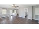 Spacious living room featuring wood floors, neutral paint, and access to kitchen and bathroom at 283 Raynor Rd, Spring Lake, NC 28390