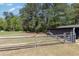 Picturesque property showcasing fencing, open green space, and mature trees on a sunny day at 283 Raynor Rd, Spring Lake, NC 28390