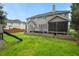 Spacious backyard featuring a screened porch, a deck, raised garden beds, and a play set at 3 Haycox Ct, Durham, NC 27713