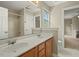 Well-lit bathroom featuring a double vanity, neutral color scheme, and tile shower at 3 Haycox Ct, Durham, NC 27713