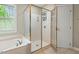 Bright bathroom featuring a soaking tub and glass-enclosed shower, offering a spa-like experience at 3 Haycox Ct, Durham, NC 27713
