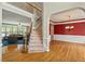 Bright foyer featuring hardwood floors, staircase, and a view into the living room and dining room at 3 Haycox Ct, Durham, NC 27713