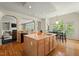 Open kitchen with a large center island, hardwood floors, and breakfast nook with backyard views at 3 Haycox Ct, Durham, NC 27713