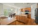 Bright kitchen with a center island, breakfast nook, stainless steel appliances, and hardwood floors at 3 Haycox Ct, Durham, NC 27713