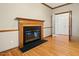 Living room with a classic fireplace, wood trim, and hardwood flooring, exuding warmth and elegance at 3 Haycox Ct, Durham, NC 27713