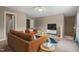 Cozy living room with comfortable seating, bright white trim, and a contemporary ceiling fan at 3 Haycox Ct, Durham, NC 27713