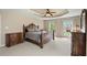 Spacious main bedroom with a tray ceiling, carpet, and ample natural light from the large windows at 3 Haycox Ct, Durham, NC 27713