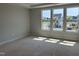 Bright bedroom featuring three large windows showcasing neighborhood views at 3020 White Rail Dr, Fuquay Varina, NC 27526