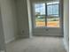 A bedroom with a large window showing the neighborhood playground at 3020 White Rail Dr, Fuquay Varina, NC 27526