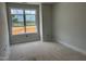 A bedroom with a large window showing a view of the construction site at 3020 White Rail Dr, Fuquay Varina, NC 27526