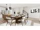 Dining area open to kitchen and stairwell featuring modern dining table and chairs at 3020 White Rail Dr, Fuquay Varina, NC 27526
