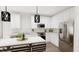 Modern kitchen design with white cabinets, stainless steel appliances, quartz counters, and stylish pendant lighting at 3020 White Rail Dr, Fuquay Varina, NC 27526