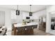 Modern kitchen with stainless steel appliances, a center island, and stylish pendant lighting at 3020 White Rail Dr, Fuquay Varina, NC 27526
