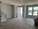 Spacious living room with large windows, modern railing staircase, and front door at 3020 White Rail Dr, Fuquay Varina, NC 27526