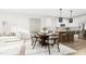 Open-concept living room and dining area with modern furnishings and natural light at 3020 White Rail Dr, Fuquay Varina, NC 27526
