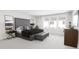 Well-lit main bedroom features a large bed, accent furniture, and a wall of windows at 3020 White Rail Dr, Fuquay Varina, NC 27526
