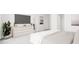Serene main bedroom with a gray upholstered bed, light-colored dresser, and minimalist decor at 3020 White Rail Dr, Fuquay Varina, NC 27526