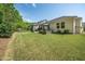 Lush backyard featuring a manicured lawn, patio with seating, and privacy fencing at 3029 Willow Ranch Dr, Fuquay Varina, NC 27526