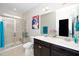 Bright bathroom featuring a double vanity, glass shower, and stylish décor at 3029 Willow Ranch Dr, Fuquay Varina, NC 27526