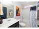 Bathroom with a shower-tub combination, neutral tile, and dark vanity at 3029 Willow Ranch Dr, Fuquay Varina, NC 27526