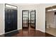 Inviting foyer with a black front door, hardwood floors, and french doors leading to another room at 3029 Willow Ranch Dr, Fuquay Varina, NC 27526