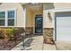 Close-up of the front entrance showcasing a charming bench, stone accents, and stylish exterior lighting at 3029 Willow Ranch Dr, Fuquay Varina, NC 27526