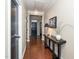 Long hallway with hardwood floors, a console table, and a view of the front door at 3029 Willow Ranch Dr, Fuquay Varina, NC 27526