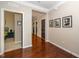 Hallway with hardwood floors and neutral walls that lead to multiple rooms at 3029 Willow Ranch Dr, Fuquay Varina, NC 27526