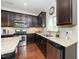 Functional kitchen layout with granite counters, stainless steel appliances, and dark cabinetry at 3029 Willow Ranch Dr, Fuquay Varina, NC 27526