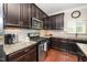 Well-appointed kitchen features stainless steel appliances, granite countertops, and dark wood cabinetry at 3029 Willow Ranch Dr, Fuquay Varina, NC 27526