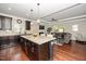 Open-concept kitchen and living room with hardwood floors, granite countertops, and cozy fireplace at 3029 Willow Ranch Dr, Fuquay Varina, NC 27526