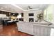 Open-concept living room and kitchen with a fireplace, dark cabinetry, and hardwood flooring at 3029 Willow Ranch Dr, Fuquay Varina, NC 27526