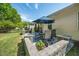 Charming patio with a dining set, potted plants, and partial shade for relaxing outdoors at 3029 Willow Ranch Dr, Fuquay Varina, NC 27526