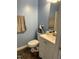 Compact bathroom with a toilet, a vanity, and blue walls at 303 Smith Level Rd # E32, Chapel Hill, NC 27516