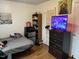 Cozy bedroom with a TV on dresser, featuring sleek design and fun artwork at 303 Smith Level Rd # E32, Chapel Hill, NC 27516