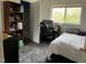 Comfortable bedroom featuring a bed, desk area, and view outside the window, carpeted with gray rug at 303 Smith Level Rd # E32, Chapel Hill, NC 27516