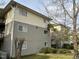 View of a multi-Gathering building, featuring neutral-toned siding and manicured landscaping, with a building letter E visible at 303 Smith Level Rd # E32, Chapel Hill, NC 27516