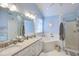 Bathroom featuring a corner tub, shower, and double vanity sinks with granite counters at 3100 Benton Cir, Raleigh, NC 27615