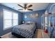 Bedroom with a ceiling fan, a bed with patterned bedding, and natural light from the window at 3100 Benton Cir, Raleigh, NC 27615