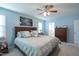Bright bedroom featuring a queen-sized bed, ceiling fan, and light blue paint at 3100 Benton Cir, Raleigh, NC 27615